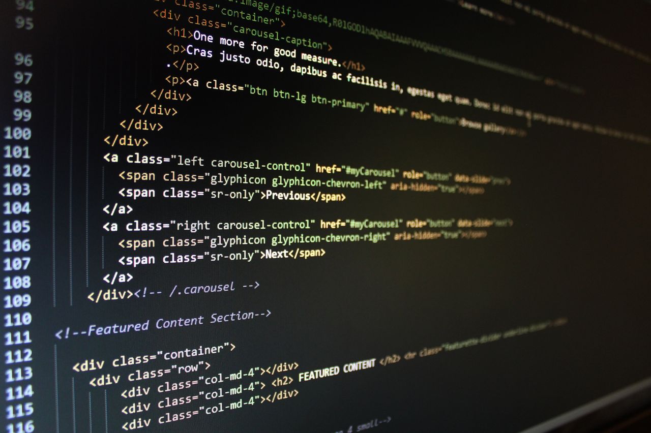 Home Close-up of HTML code displayed on a computer monitor, showcasing web development.