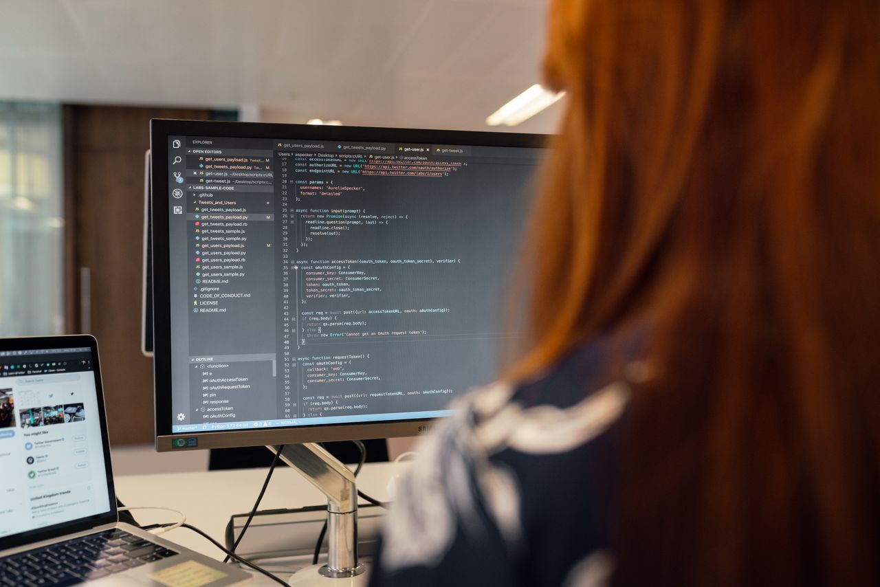 Home A female engineer works on code in a contemporary office setting, showcasing software development.